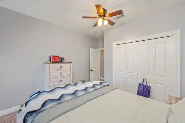 a bedroom with a bed and a chandelier