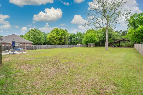 a view of a house with a backyard porch and sitting area