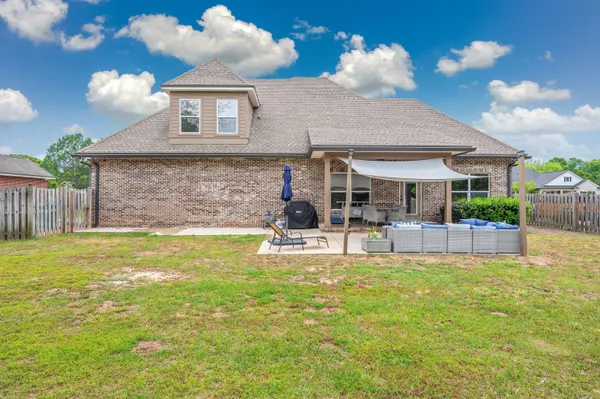 a view of a chair and tables in the patio