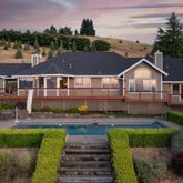 an aerial view of a house with garden space and lake view