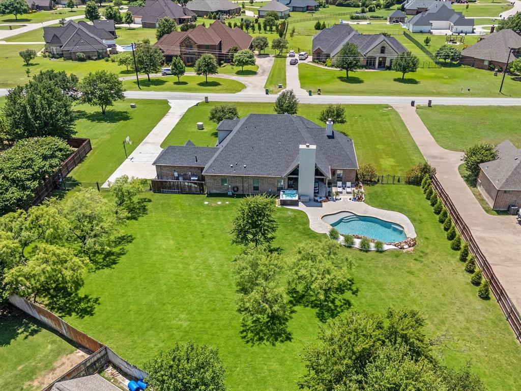 111 Old Base Road Aurora, TX 76078 - Photo 4 of 38 Beautifully updated custom home situated on a one-acre lot in Aurora Vista with mature landscaping, stone accents, and exceptional curb appeal.