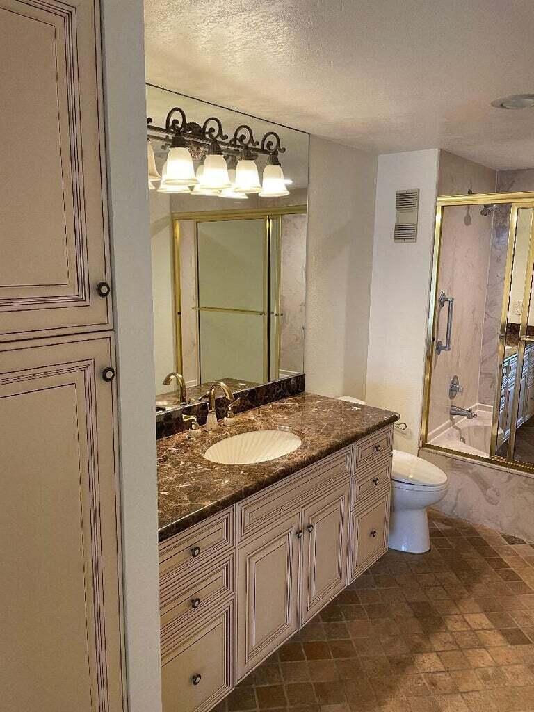 6300 Northwest 2nd Avenue, Unit 305 Boca Raton, FL 33487 - Photo 14 of 27 a bathroom with a granite countertop sink and a mirror