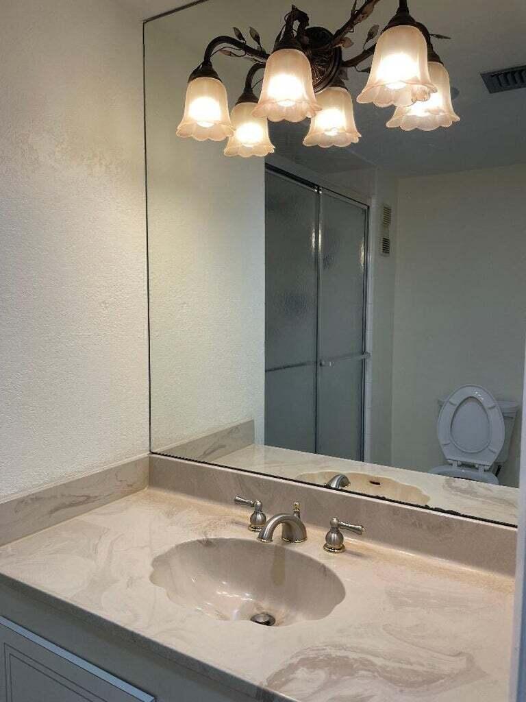 6300 Northwest 2nd Avenue, Unit 305 Boca Raton, FL 33487 - Photo 17 of 27 a bathroom with a sink and a mirror