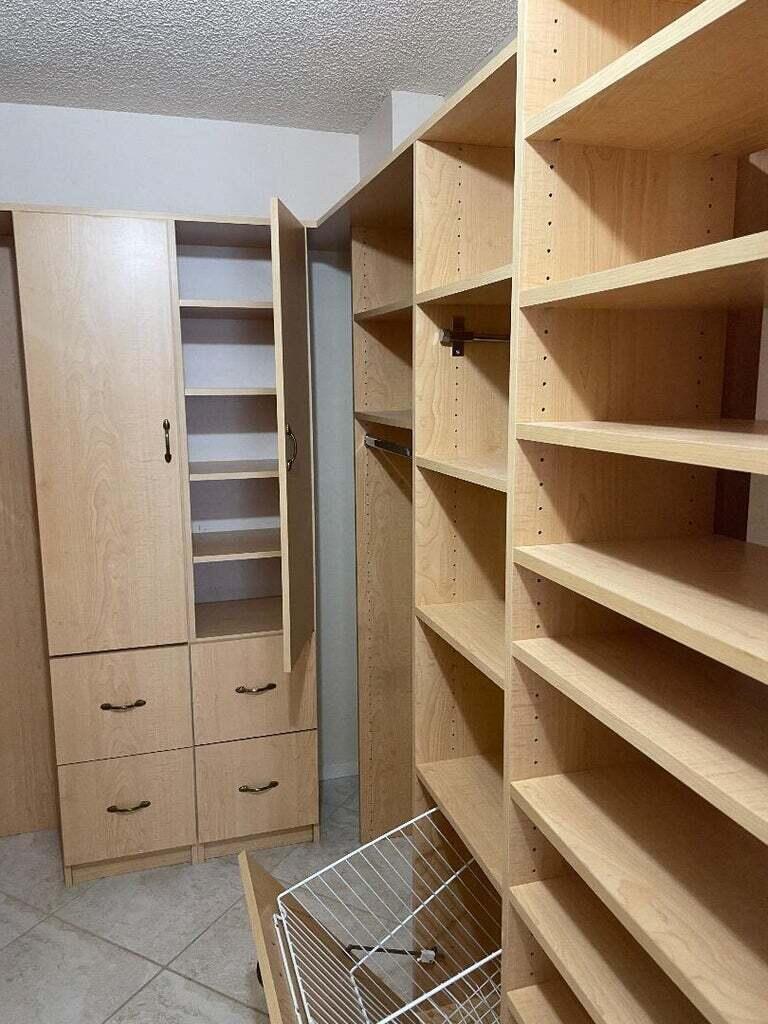 6300 Northwest 2nd Avenue, Unit 305 Boca Raton, FL 33487 - Photo 18 of 27 a view of walk in closet with empty racks