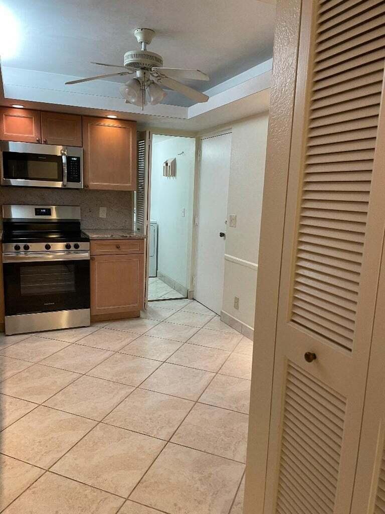 6300 Northwest 2nd Avenue, Unit 305 Boca Raton, FL 33487 - Photo 2 of 27 a kitchen with stainless steel appliances granite countertop a refrigerator and a sink