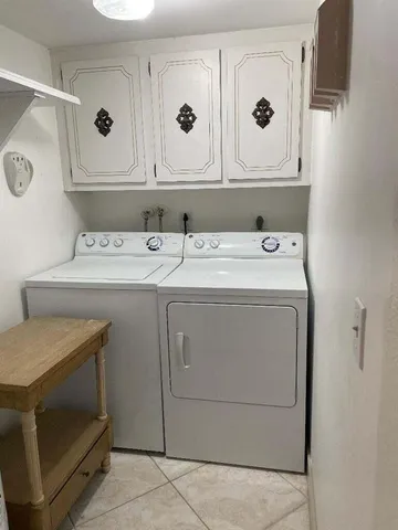 a room with lots of trees and glass door