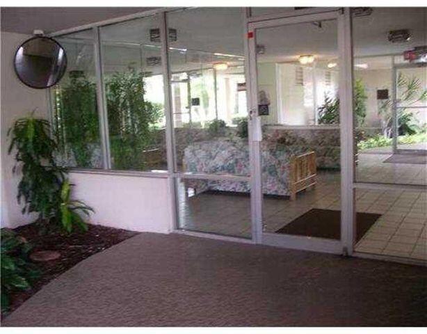 6300 Northwest 2nd Avenue, Unit 305 Boca Raton, FL 33487 - Photo 22 of 27 a room with lots of trees and glass door