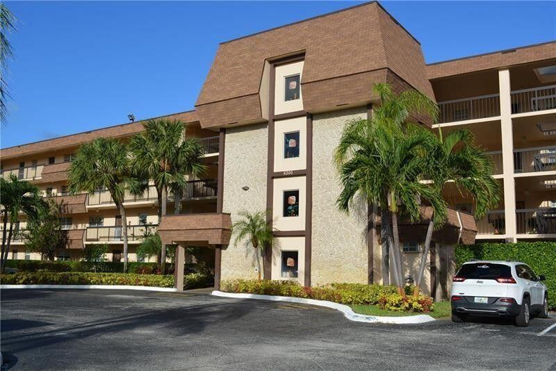 6300 Northwest 2nd Avenue, Unit 305 Boca Raton, FL 33487 - Photo 23 of 27 a front view of a building with a road