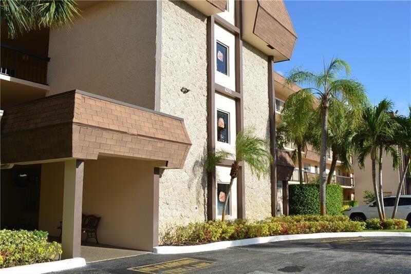 6300 Northwest 2nd Avenue, Unit 305 Boca Raton, FL 33487 - Photo 24 of 27 front view of a house with a street