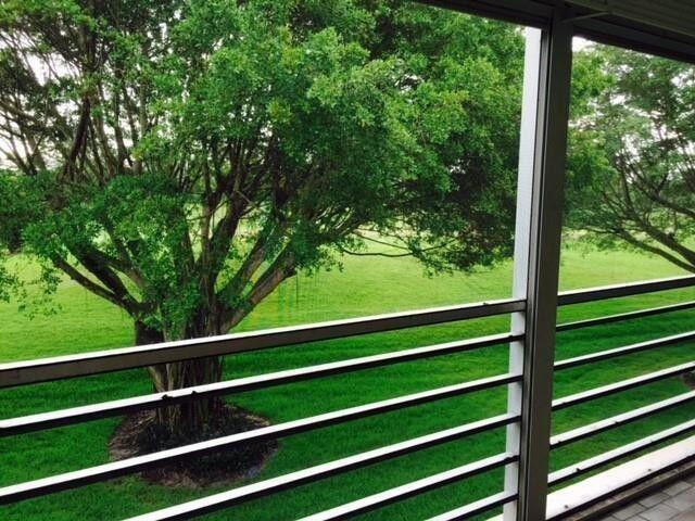 6300 Northwest 2nd Avenue, Unit 305 Boca Raton, FL 33487 - Photo 26 of 27 a view of a green field with wooden fence