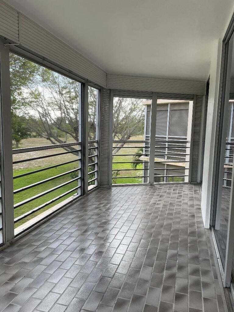 6300 Northwest 2nd Avenue, Unit 305 Boca Raton, FL 33487 - Photo 6 of 27 a view of a room with wooden floor and windows