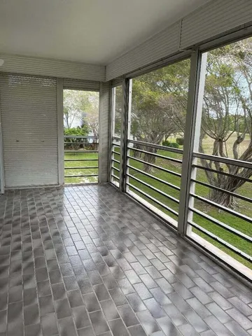 a view of a room with wooden floor and windows