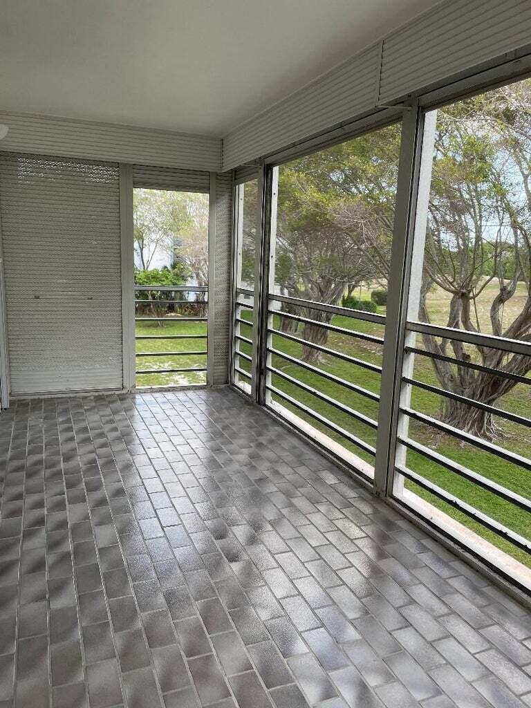 6300 Northwest 2nd Avenue, Unit 305 Boca Raton, FL 33487 - Photo 7 of 27 a view of a room with wooden floor and windows