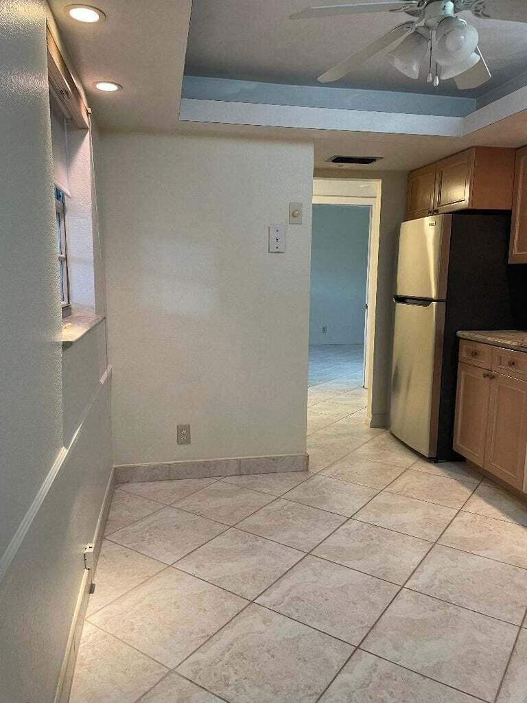 6300 Northwest 2nd Avenue, Unit 305 Boca Raton, FL 33487 - Photo 9 of 27 a view of a hallway with a refrigerator