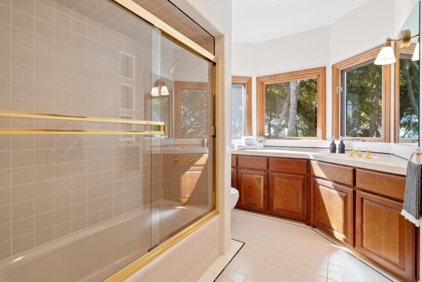 625 Quail Run Road Aptos, CA 95003 - Photo 32 of 49 a bathroom with a tub sink shower and mirror