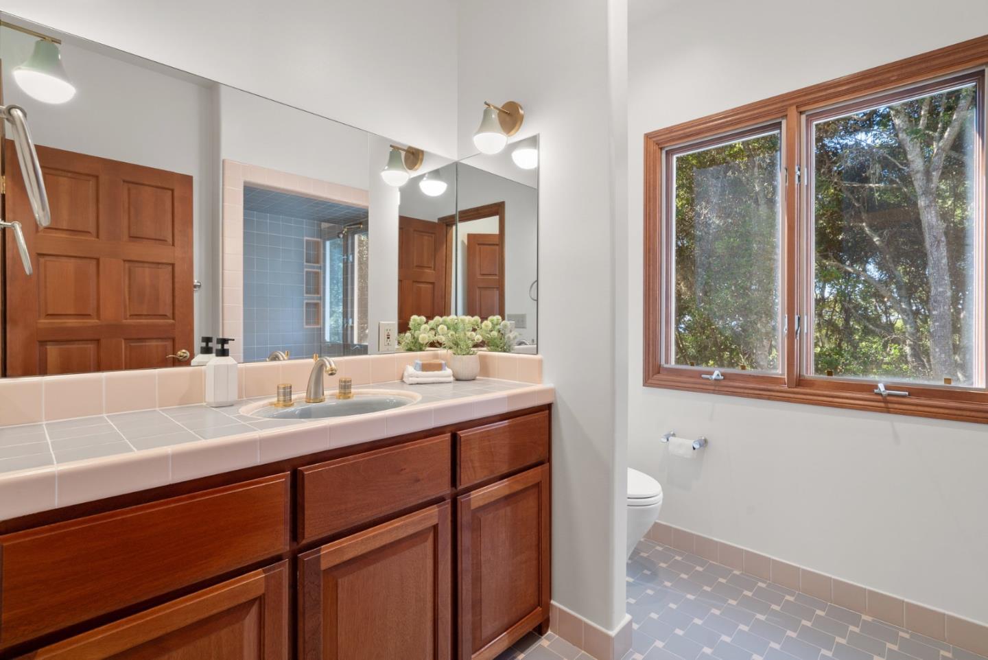 625 Quail Run Road Aptos, CA 95003 - Photo 37 of 49 a bathroom with a sink and a large mirror