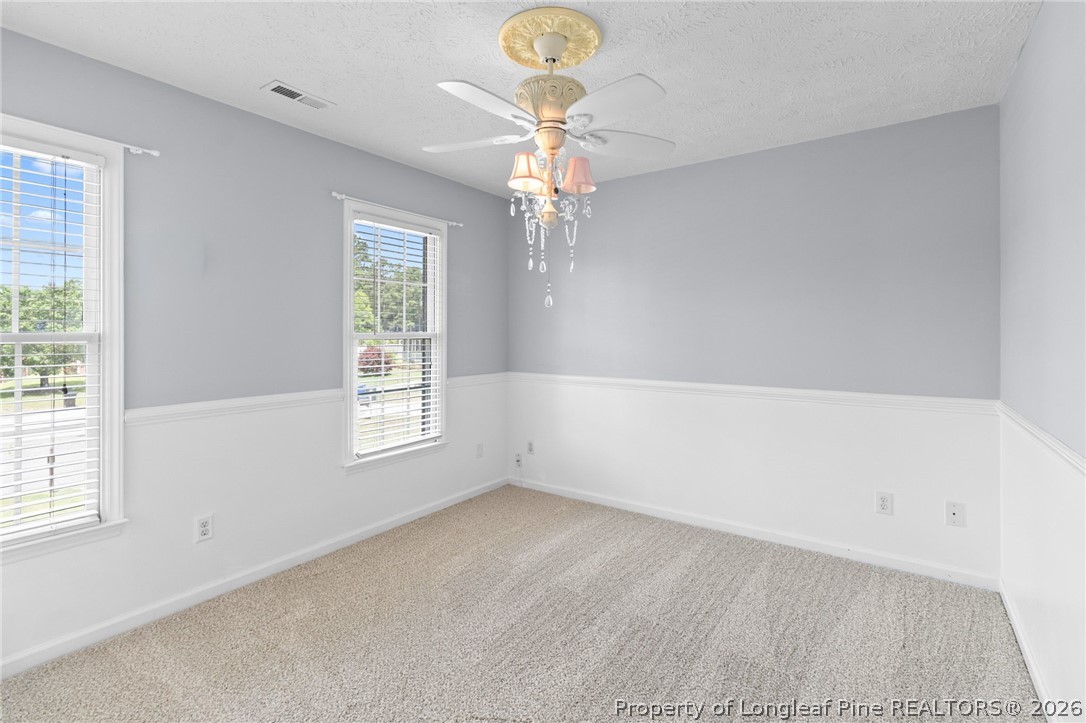 28 Coyt Circle Spring Lake, NC 28390 - Photo 25 of 41 a view of empty room with window and chandelier fan