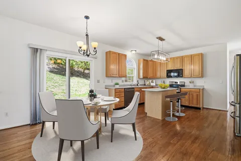 a view of a dining room with furniture window and wooden floor