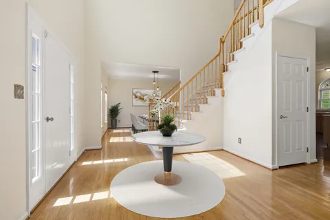 a view of entryway and hall with wooden floor