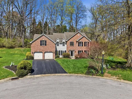an aerial view of a house with a yard and trees