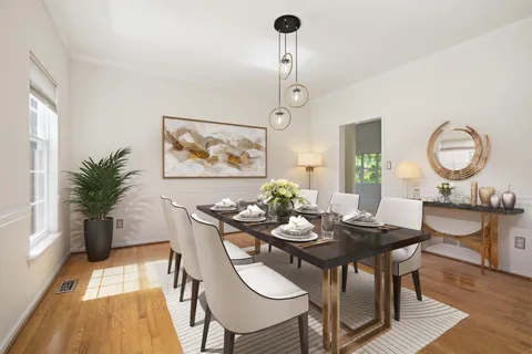 a dining room with furniture a window and wooden floor