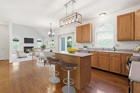 a kitchen with a sink cabinets and wooden floor