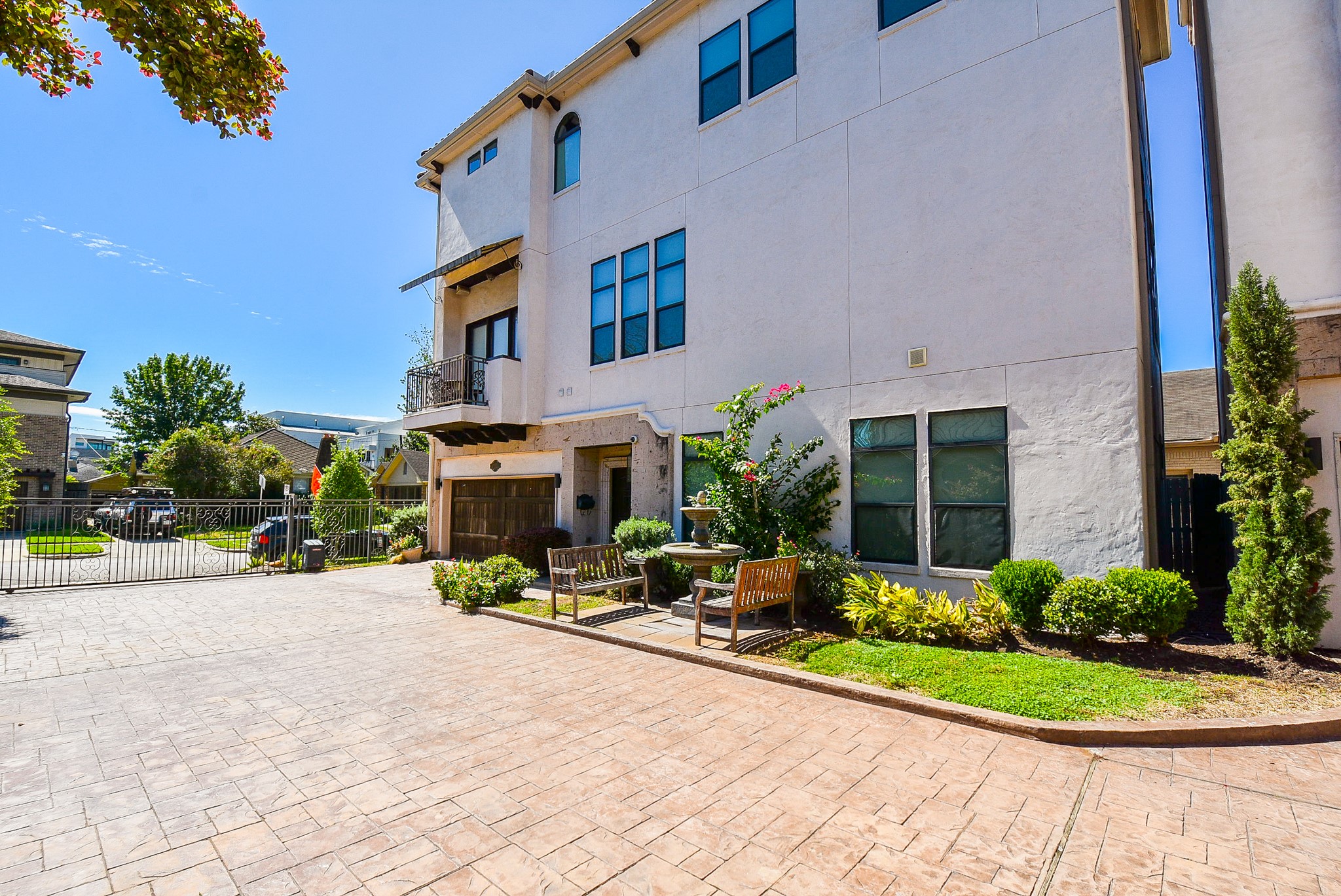 2052 West Main Street Houston, TX 77098 - Photo 1 of 32 a view of a building with potted plants and a car park in front of it