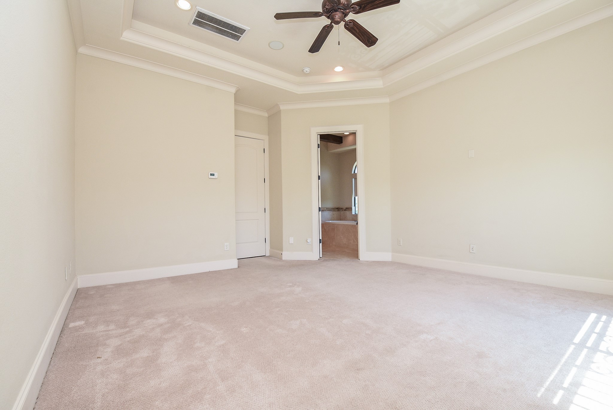 2052 West Main Street Houston, TX 77098 - Photo 18 of 32 an empty room with a ceiling fan and carpet