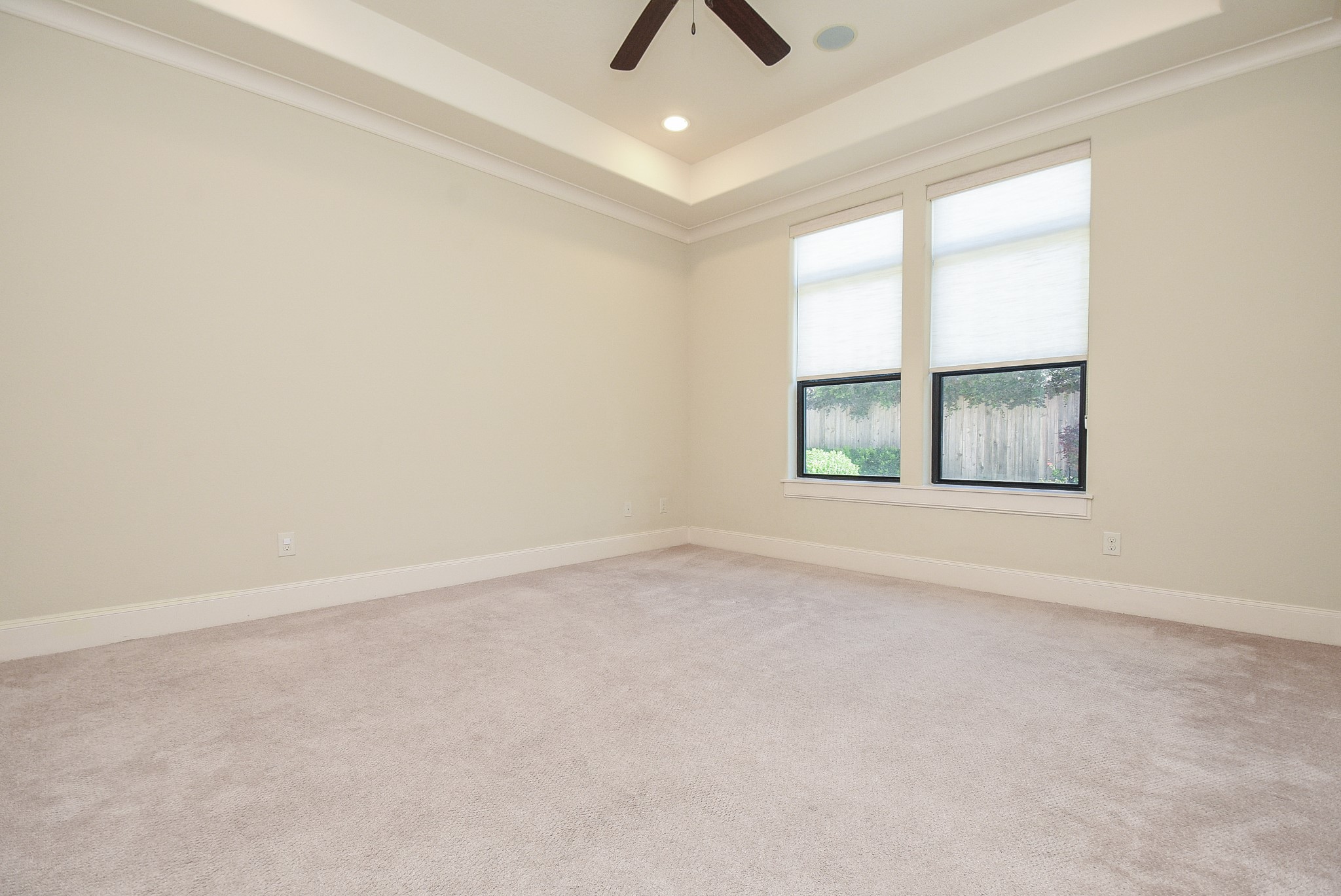 2052 West Main Street Houston, TX 77098 - Photo 23 of 32 an empty room with chandelier fan and windows