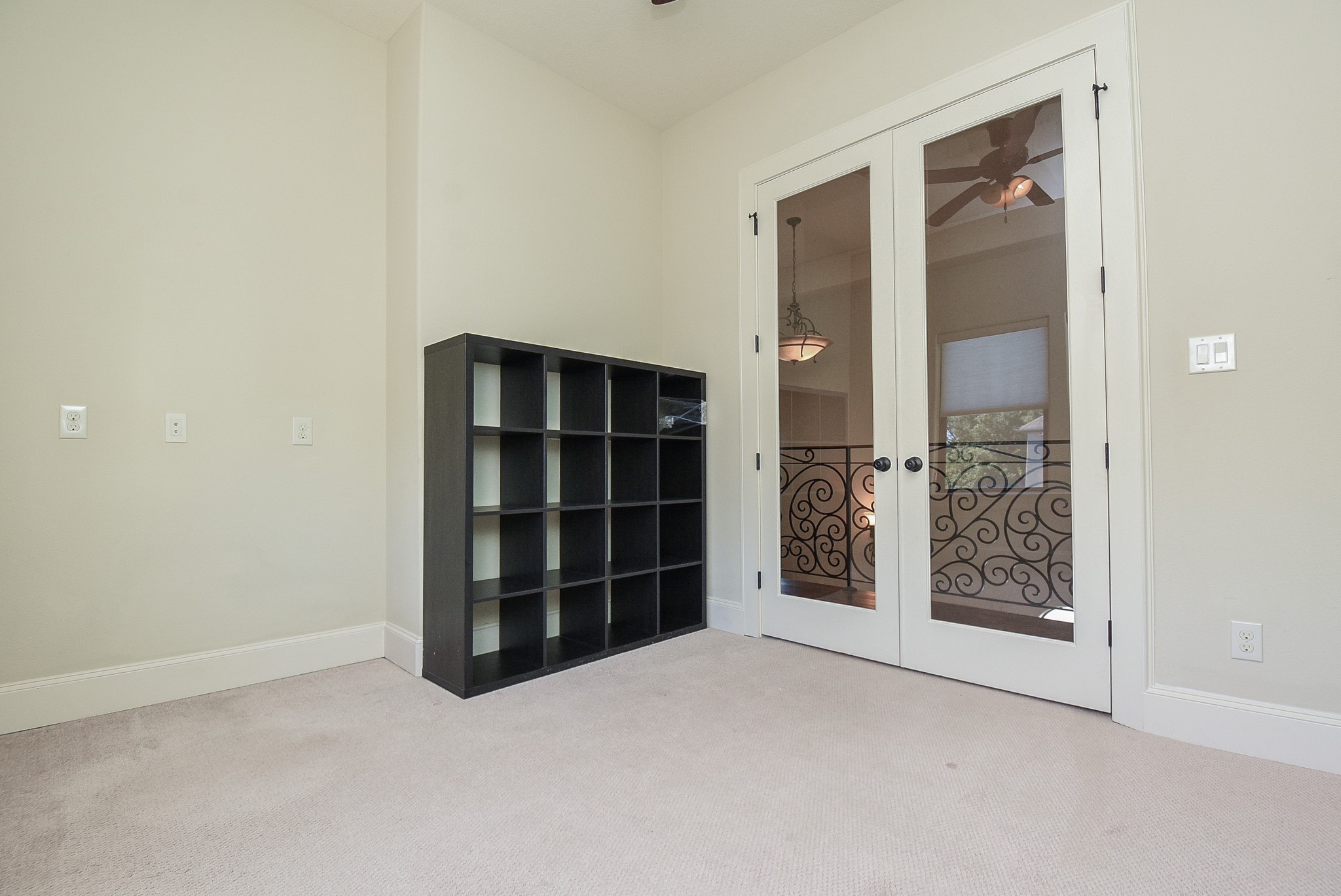 2052 West Main Street Houston, TX 77098 - Photo 25 of 32 a view of an empty room with closet and wooden shelves