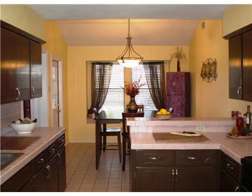 a bathroom with a sink vanity granite and a mirror