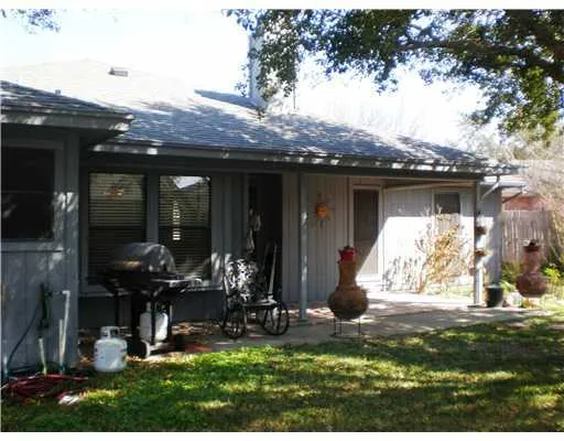 a view of a house with yard and sitting area