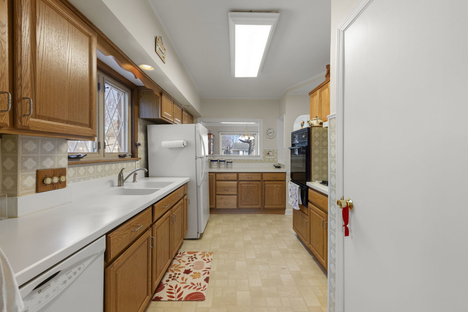370 Oak Street Elmhurst, IL 60126 - Photo 7 of 35 a kitchen with granite countertop a sink a counter top space stainless steel appliances and cabinets
