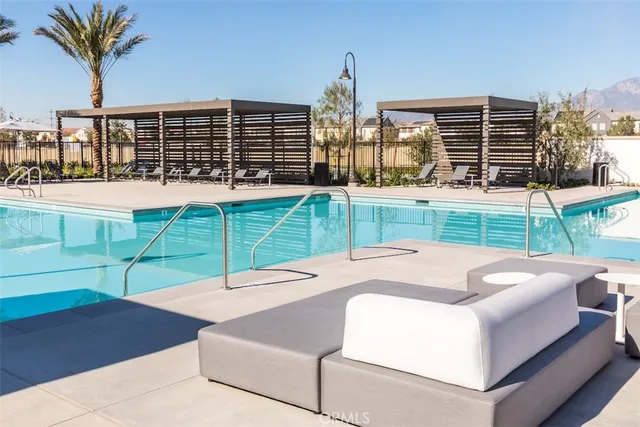 a view of a house with swimming pool and sitting area