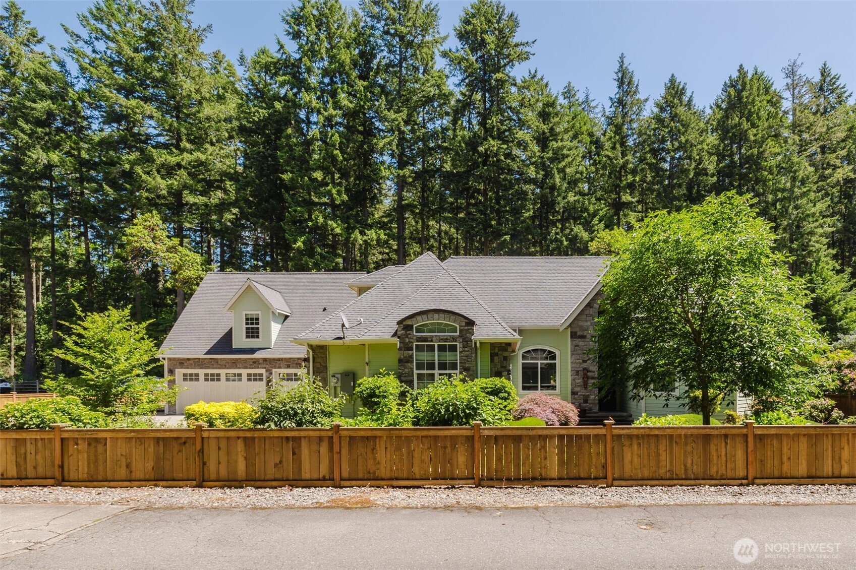 an aerial view of a house next to a yard