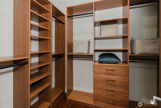 a view of walk in closet with empty racks