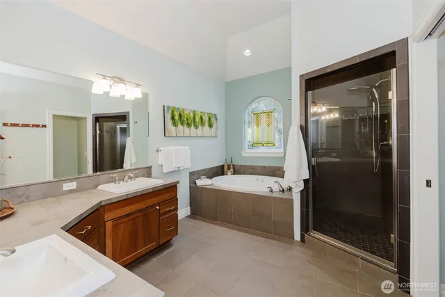 a spacious bathroom with a tub sink and mirror