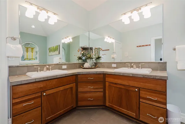a bathroom with a double vanity sink and a mirror