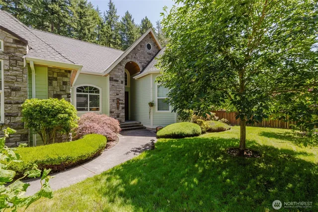a view of a house with big yard and potted plants