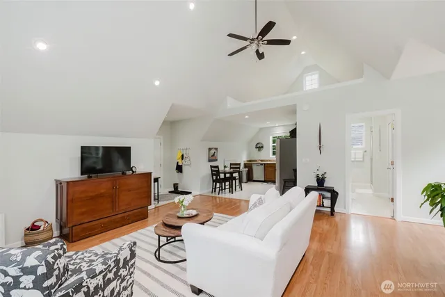 a living room with furniture and wooden floor