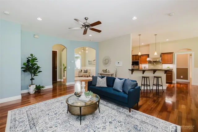 a living room with furniture and a wooden floor