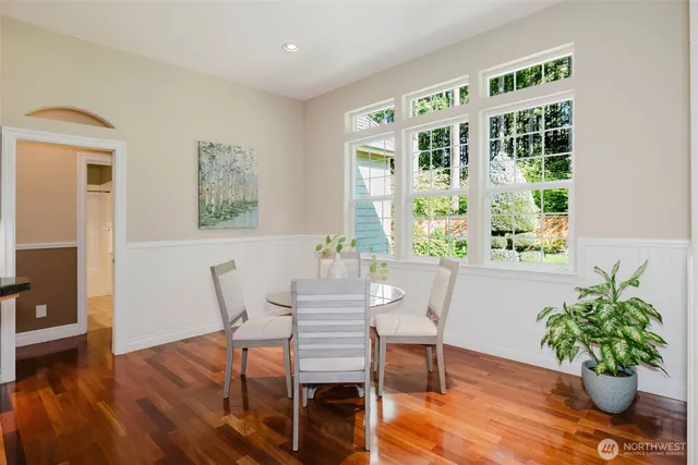 a view of a dining room with furniture window and wooden floor