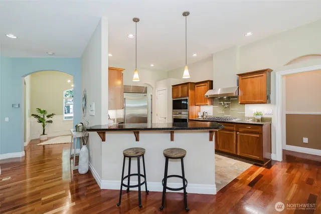 a large kitchen with a table and chairs
