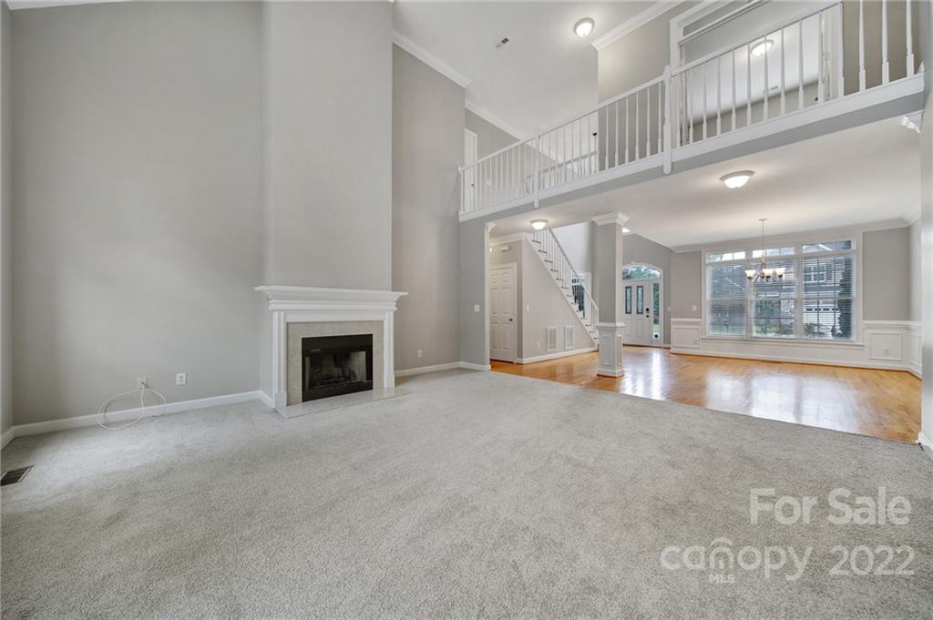 1711 Copperplate Road Charlotte, NC 28262 - Photo 12 of 48 a view of an empty room with a fireplace and a window