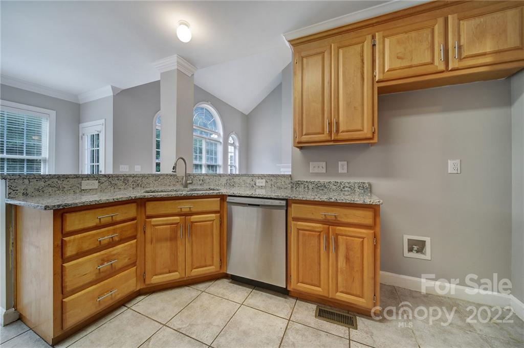 1711 Copperplate Road Charlotte, NC 28262 - Photo 15 of 48 a kitchen with stainless steel appliances granite countertop a sink and cabinets