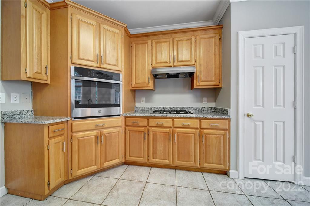 1711 Copperplate Road Charlotte, NC 28262 - Photo 16 of 48 a kitchen with stainless steel appliances granite countertop a stove a sink and a cabinets