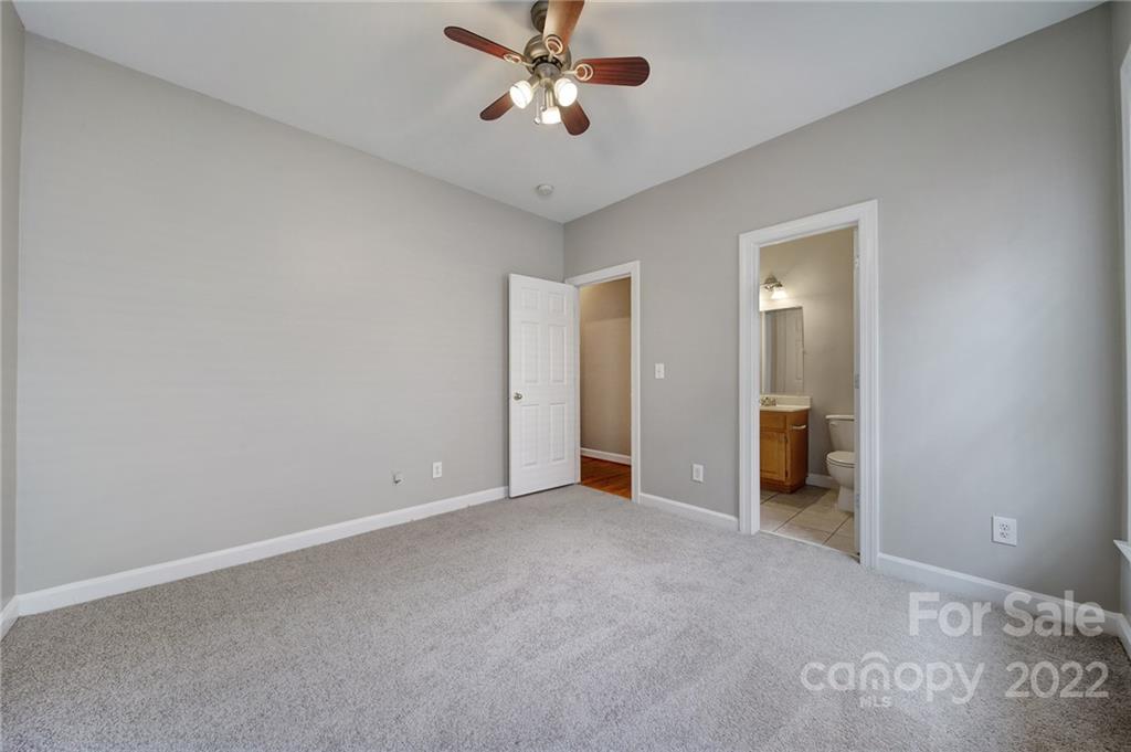 1711 Copperplate Road Charlotte, NC 28262 - Photo 25 of 48 wooden floor in an empty room and a ceiling fan