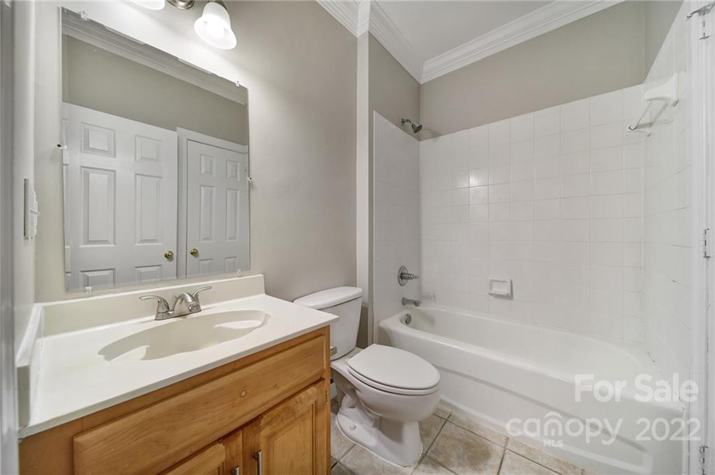 1711 Copperplate Road Charlotte, NC 28262 - Photo 26 of 48 a bathroom with a sink a toilet and shower