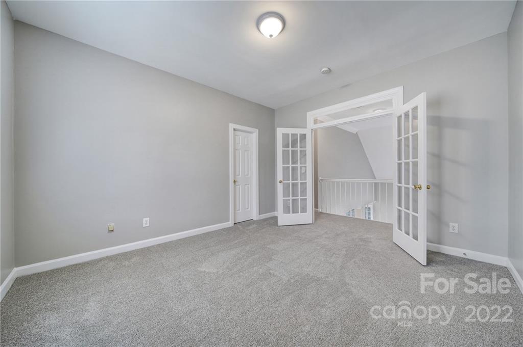 1711 Copperplate Road Charlotte, NC 28262 - Photo 30 of 48 an empty room with windows and pillars in it