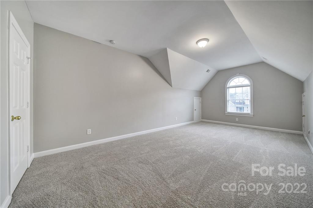 1711 Copperplate Road Charlotte, NC 28262 - Photo 32 of 48 a view of a big room with windows and chandelier fan